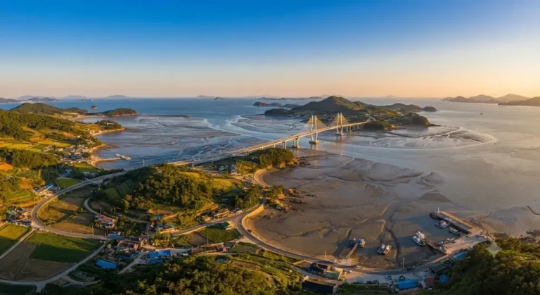 Aerial view of Aphaedo Island bridge and tidal flats during a golden sunset in South Korea